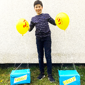 Boy with Fortnite supply boxes with yellow balloons