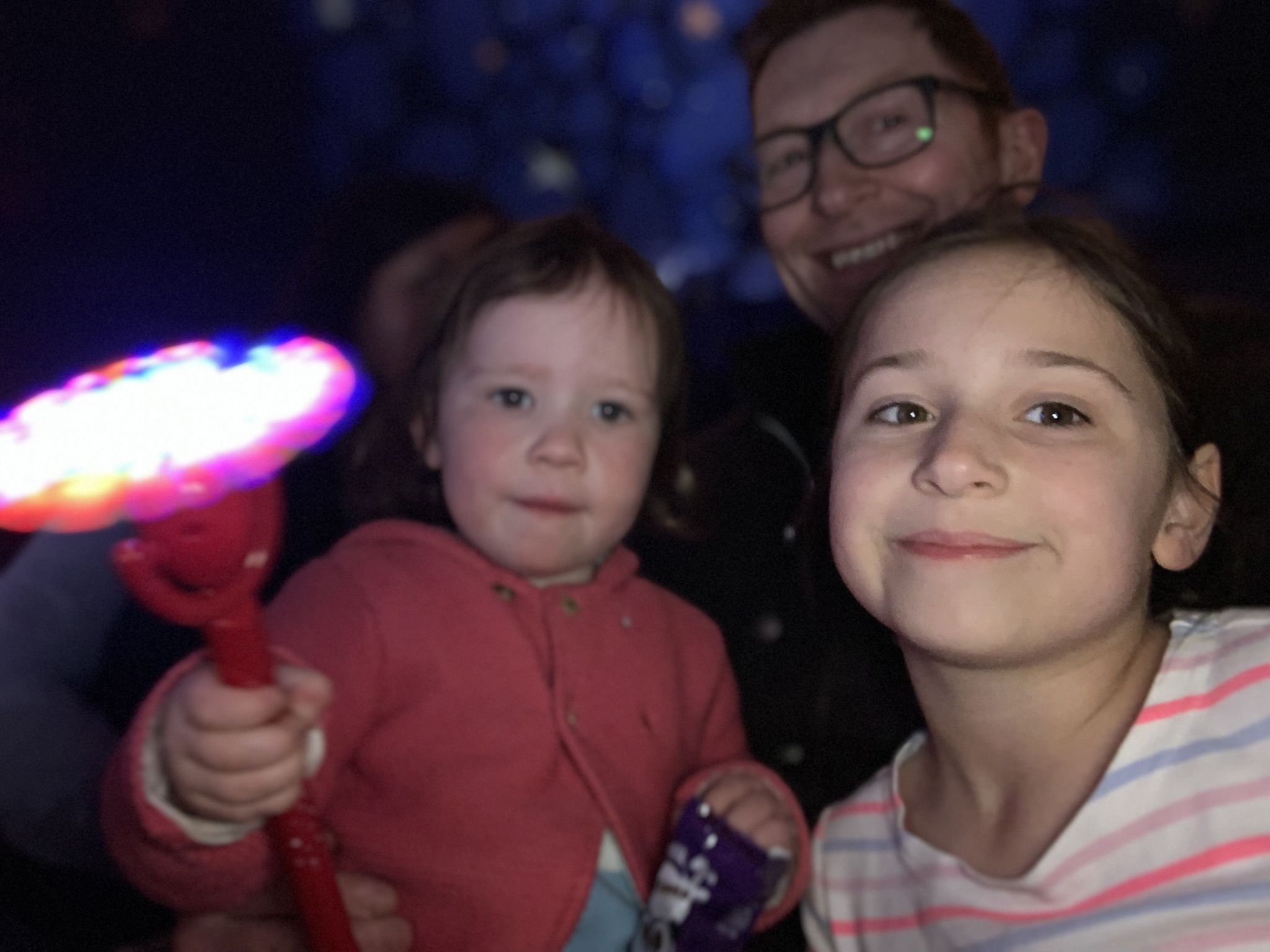 2 children and a dad enjoying watching a circus