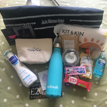 A flatlay of baby products, water bottle and snacks