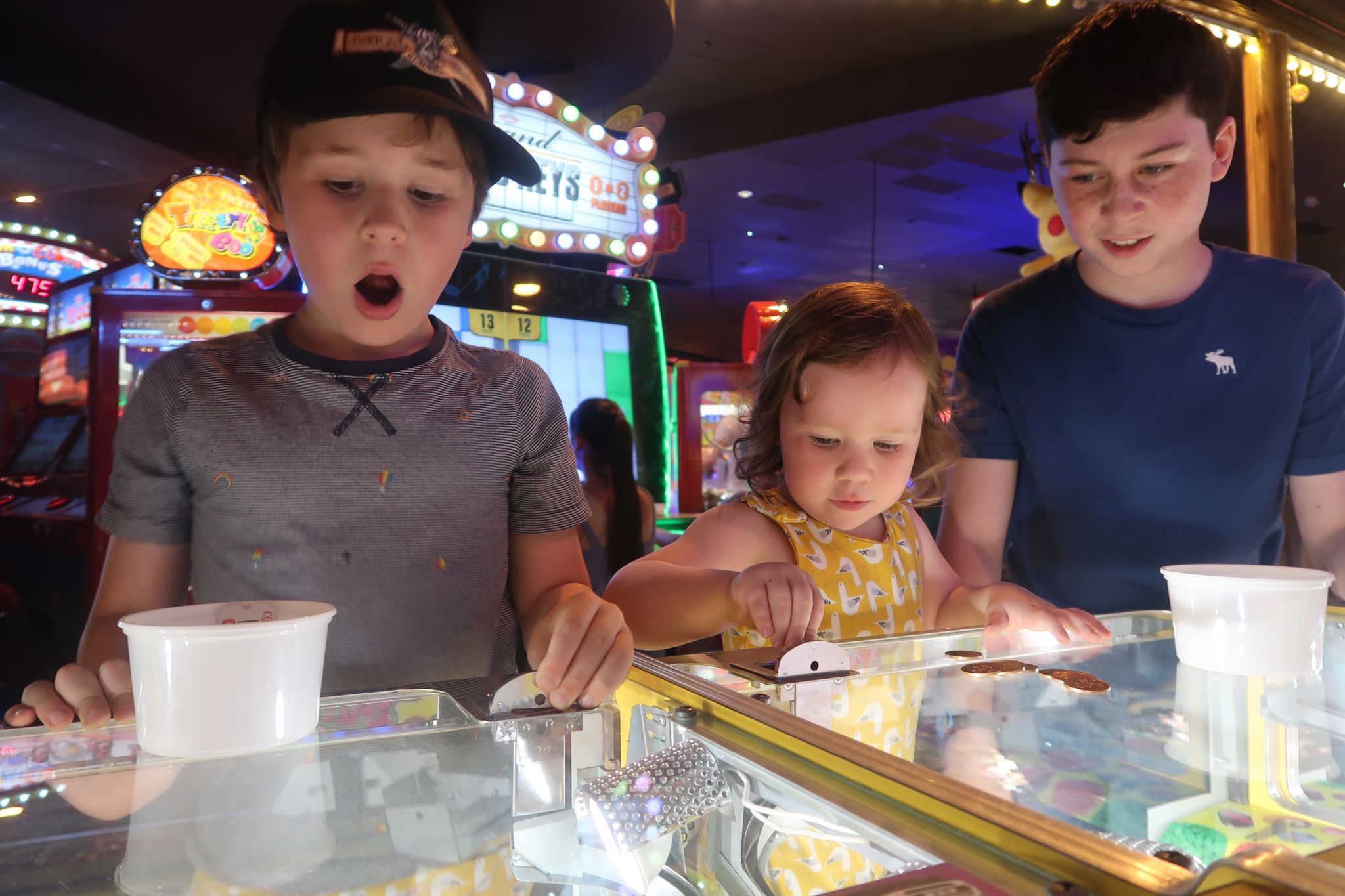 Two children playing at an amusement arcade