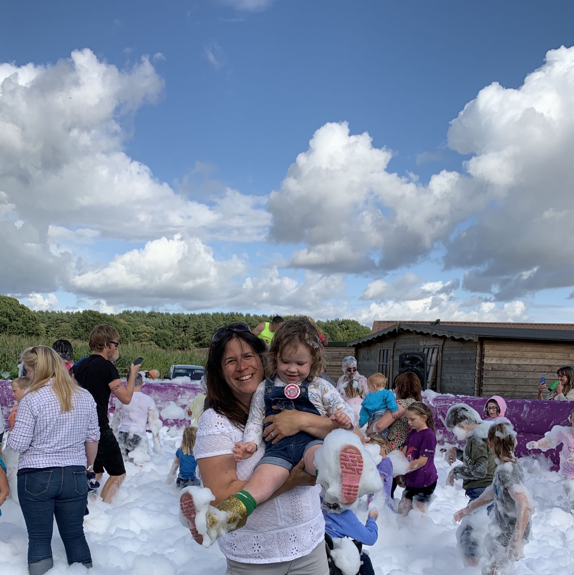 Mum and daughter playing in foam
