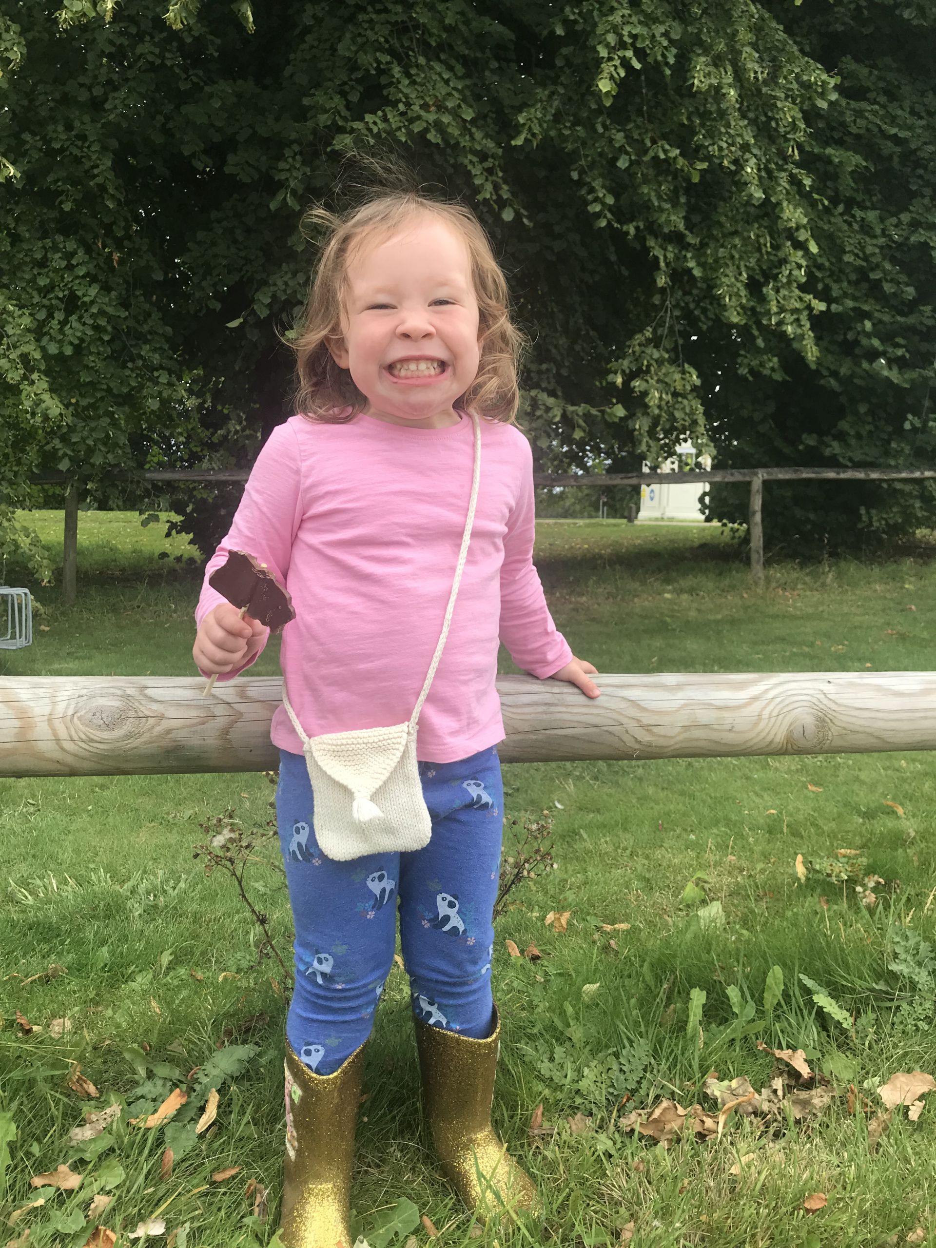 girl grinning with a chocolate lolly 
