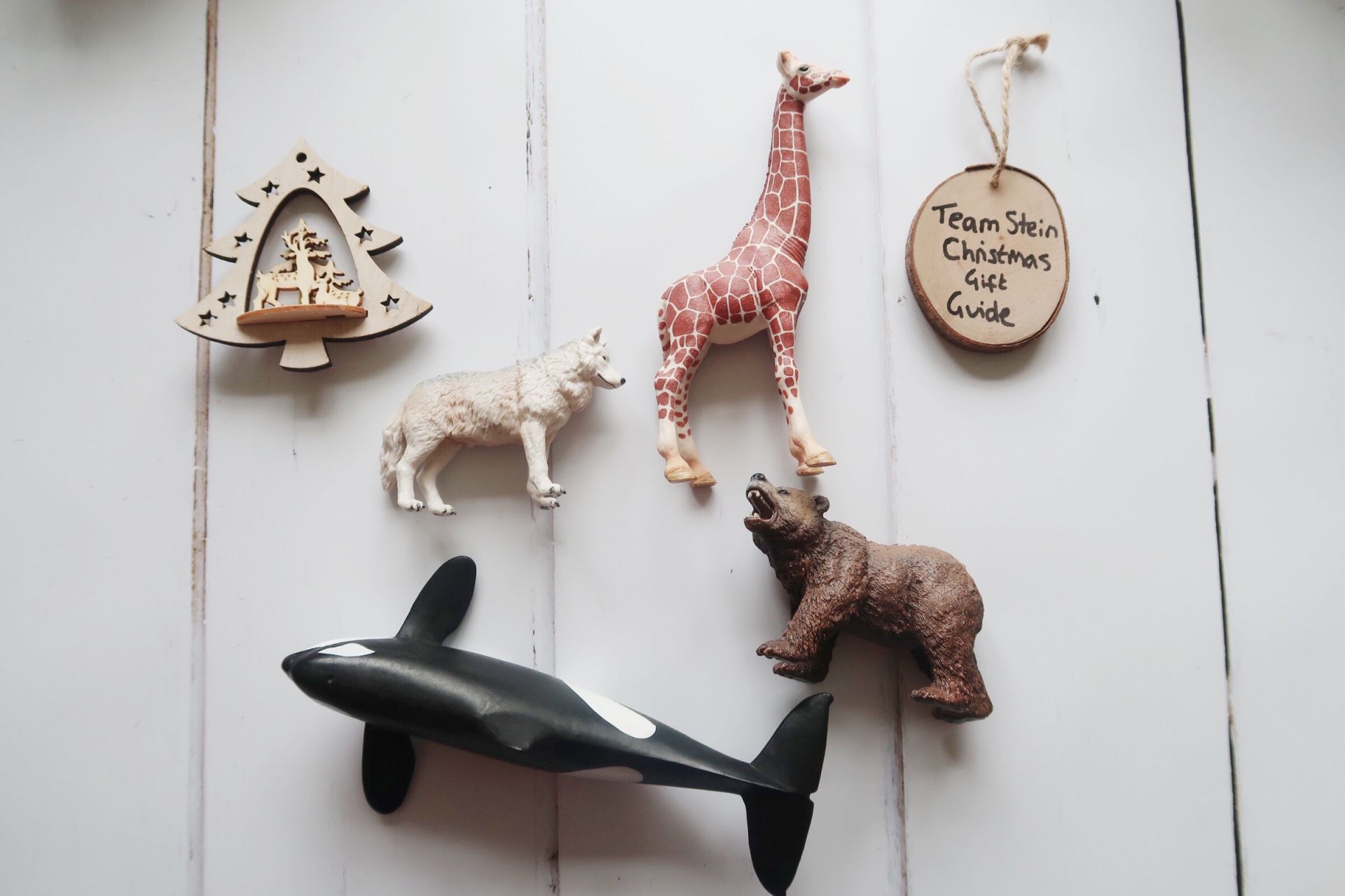 a toy wolf, giraffe, bear and whale