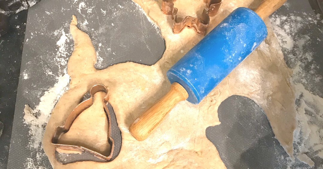 dough and rolling pin with a cookie cutter
