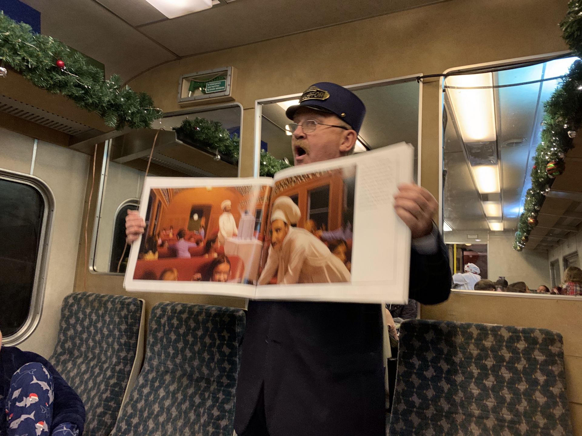 a conductor reading the polar express story 
