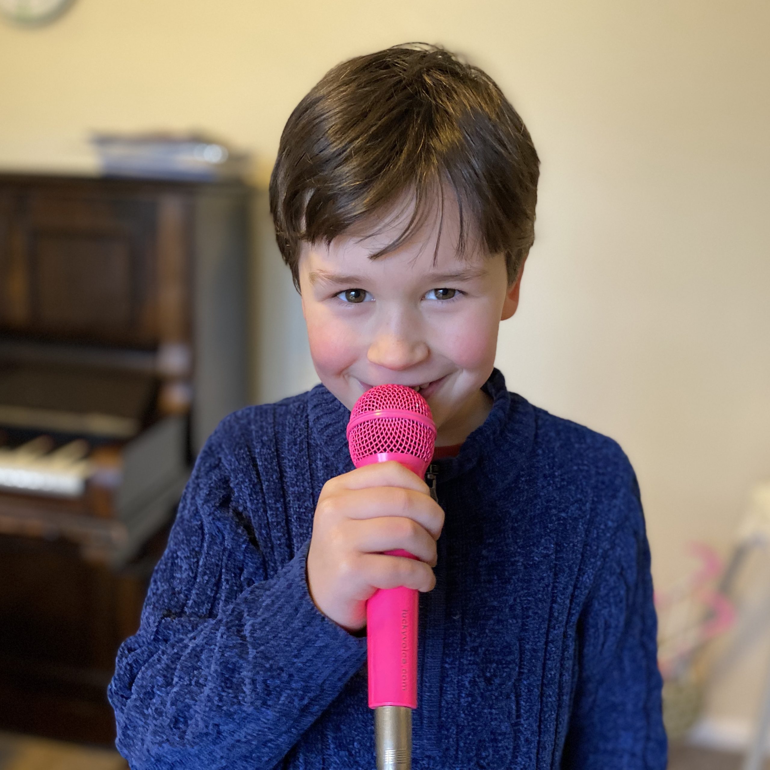 a boy singing in a microphone