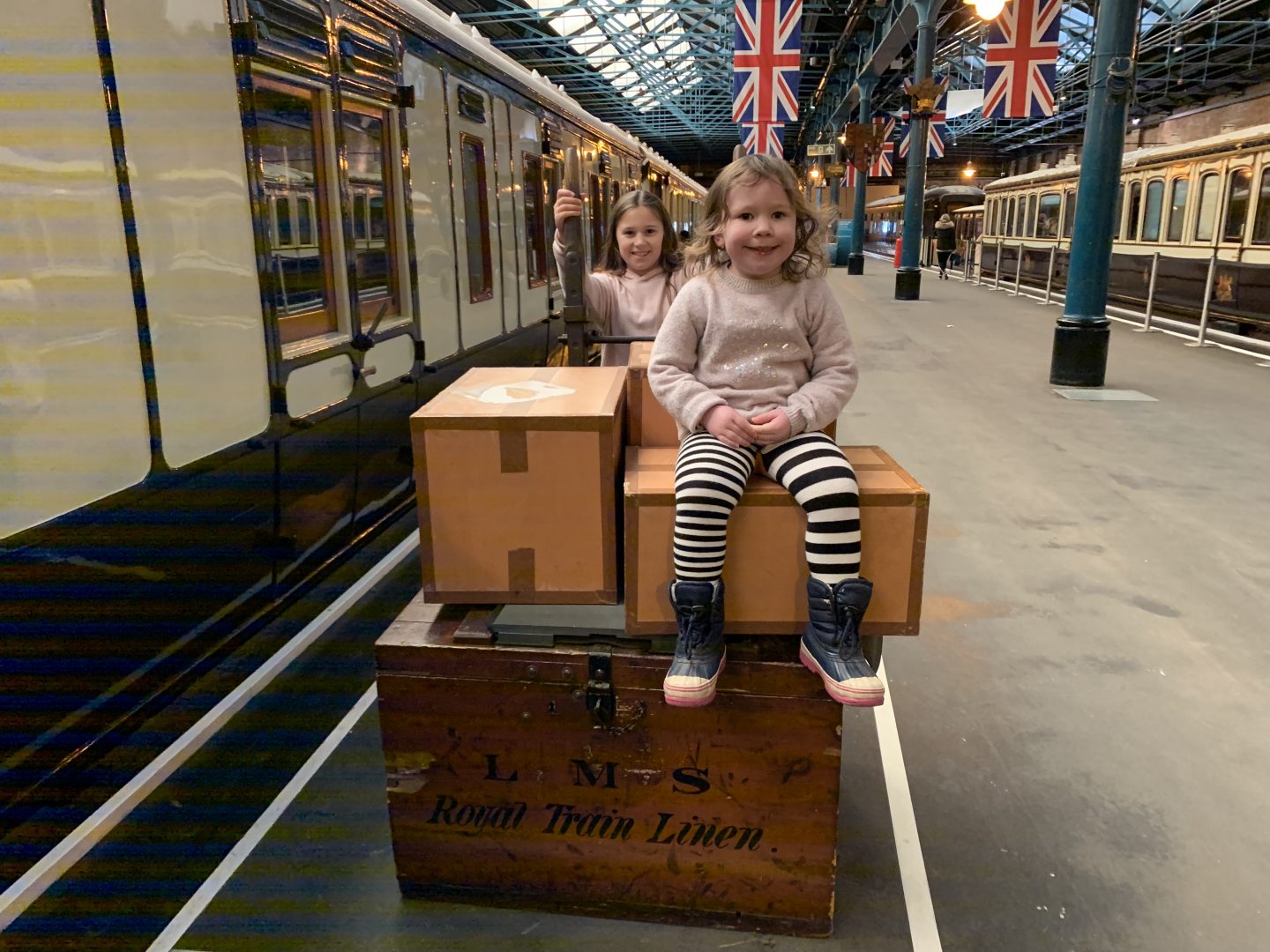 February half term activity at the Railway museum a picture of a train and luggage cart with two children