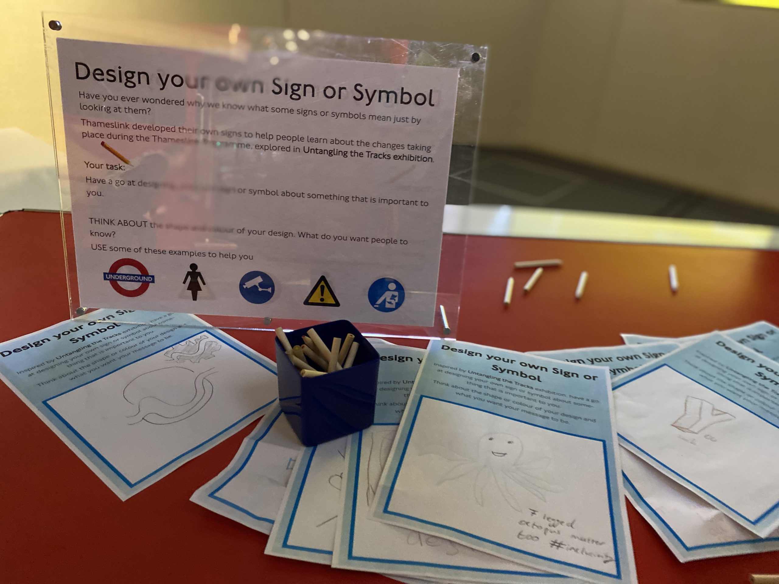 Colouring pencils and paper for designing transport signs