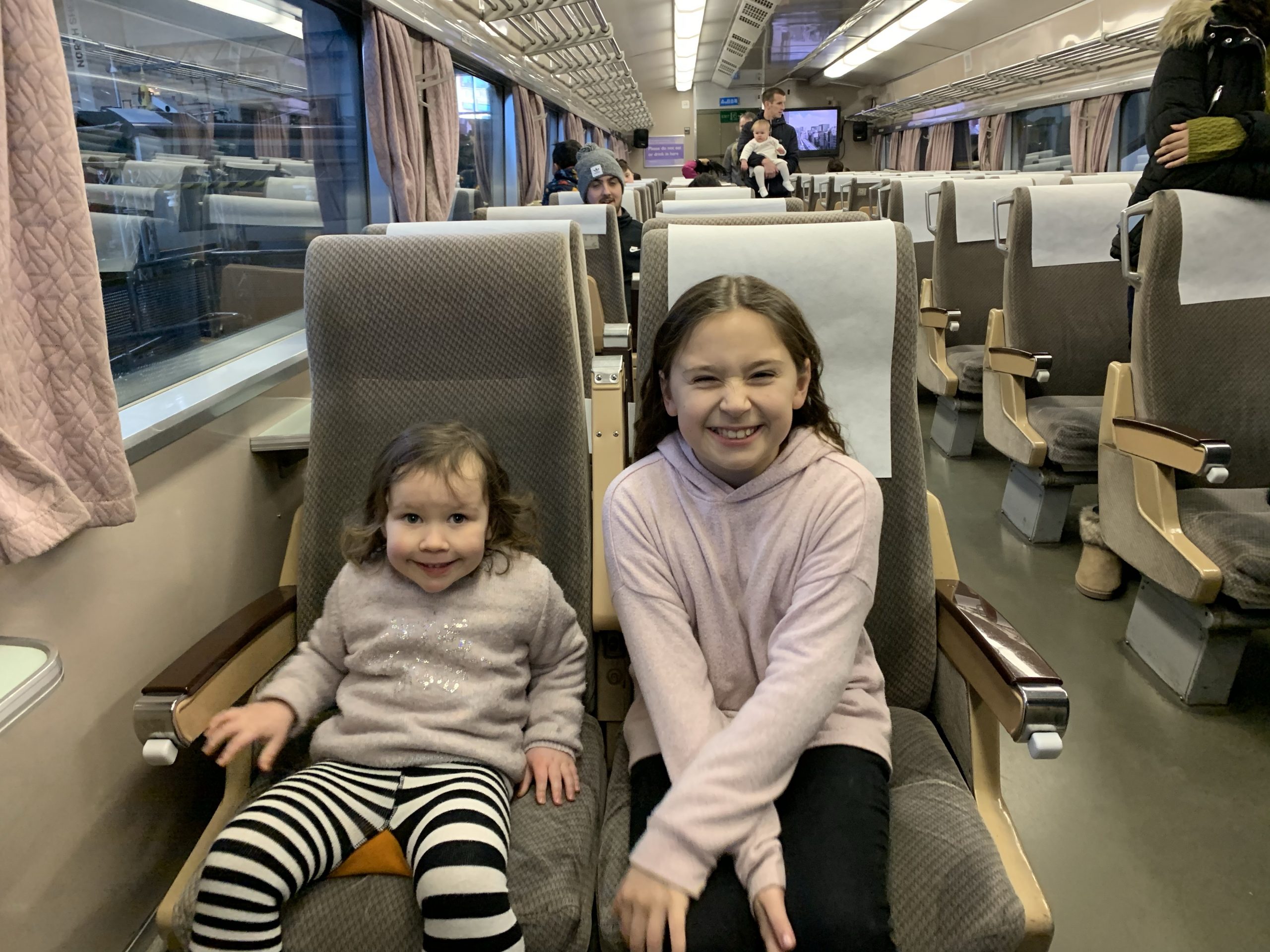 2 girls sat on a train at the York Railway Museum 