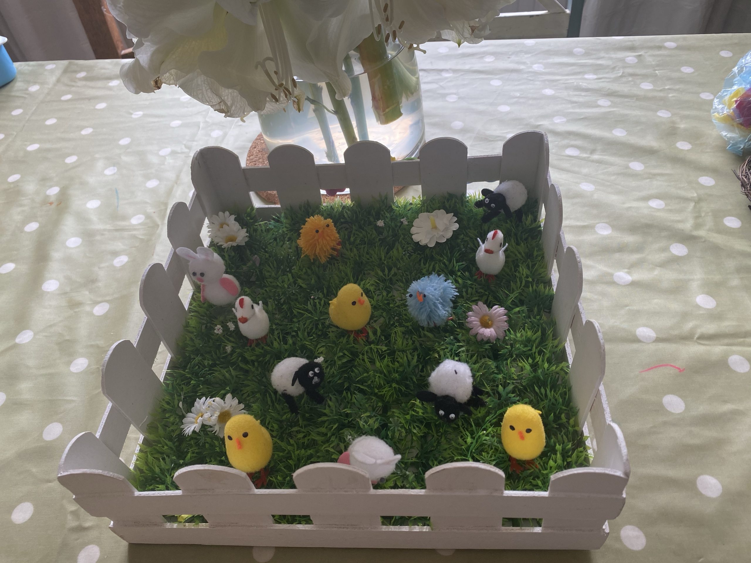 a faux Easter garden filled with little chicks, bunnies, sheeps and geese