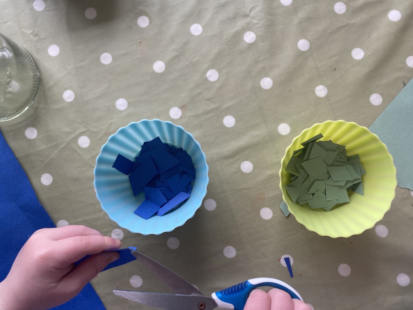 children cutting coloured paper 
