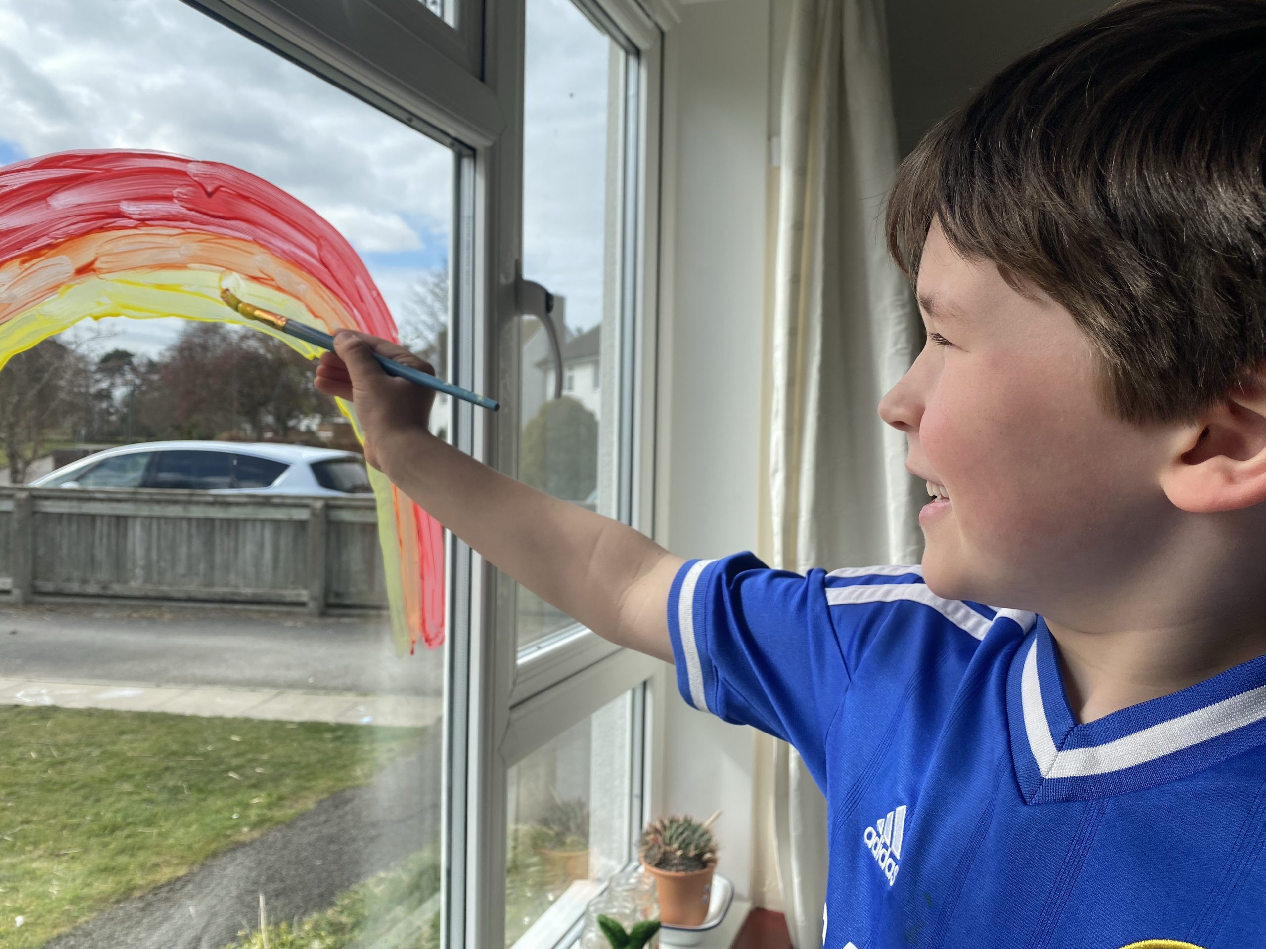 Living Arrows a boy painting a rainbow 