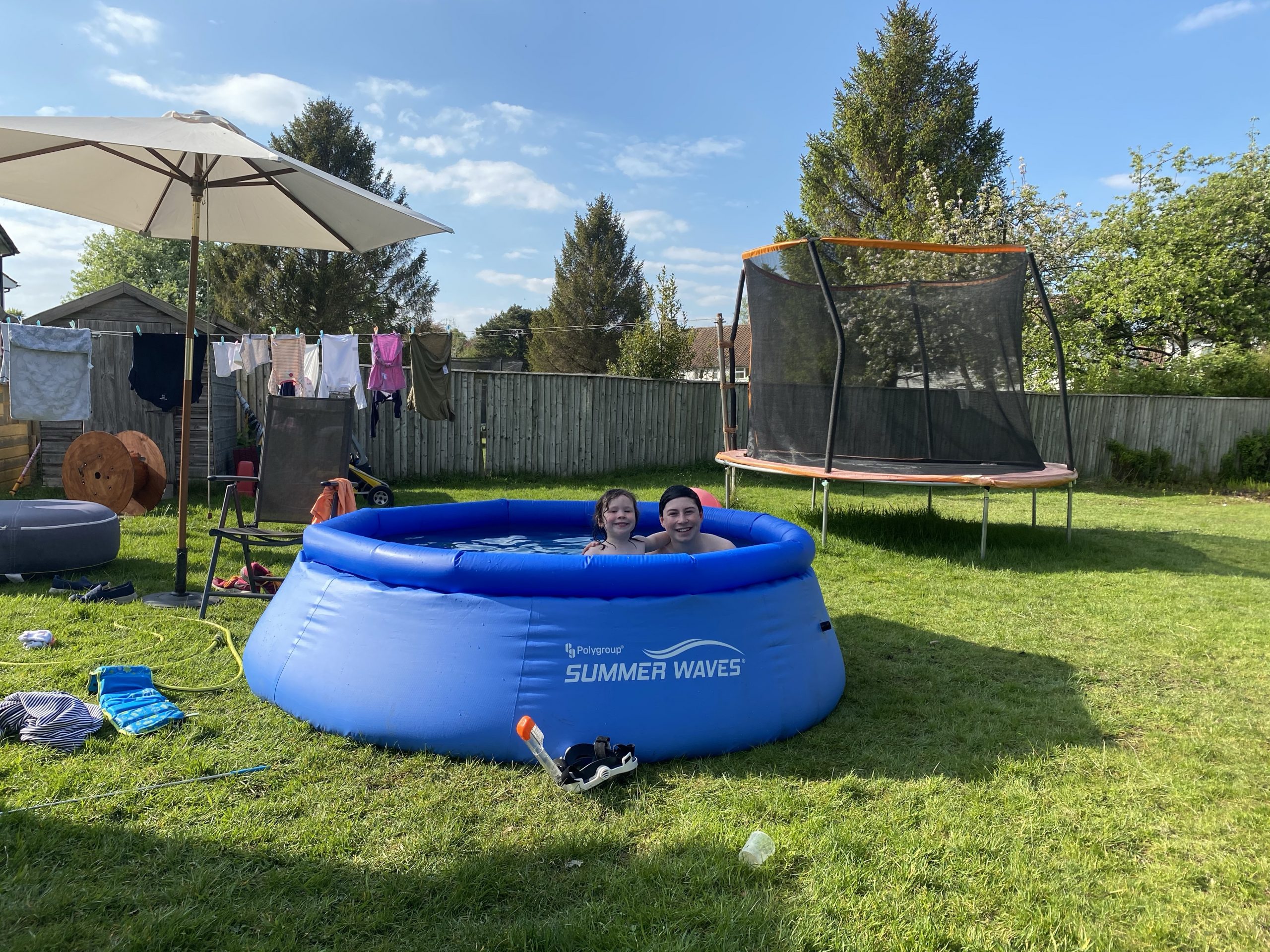 two children enjoying sunny days in the pool