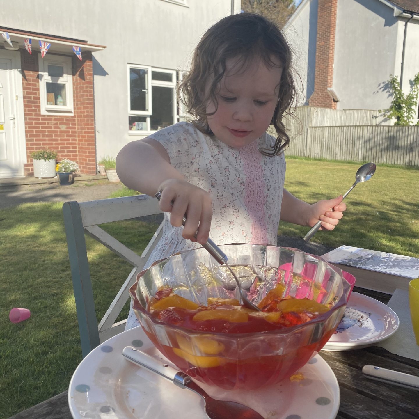 a child enjoying VE Day celebrations eating jelly