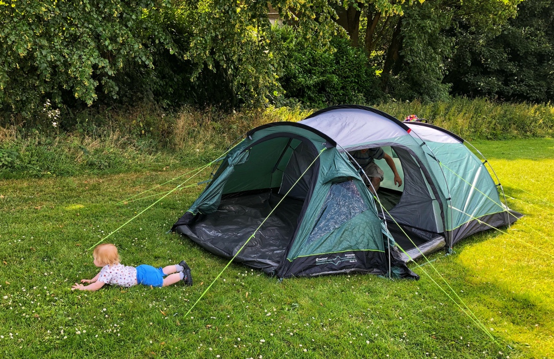 Tent and a baby playing outside