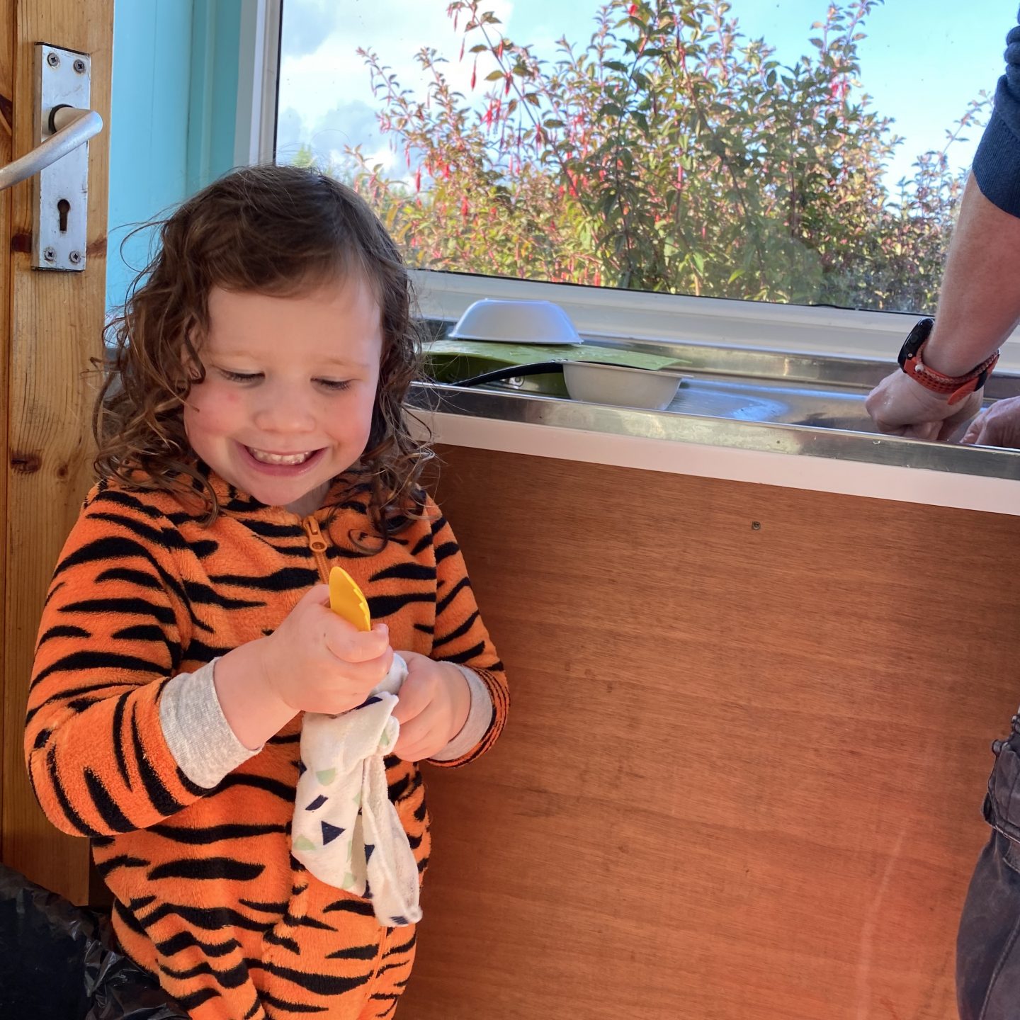 Organising for our family holiday with a young child washing up in the camp kitchen