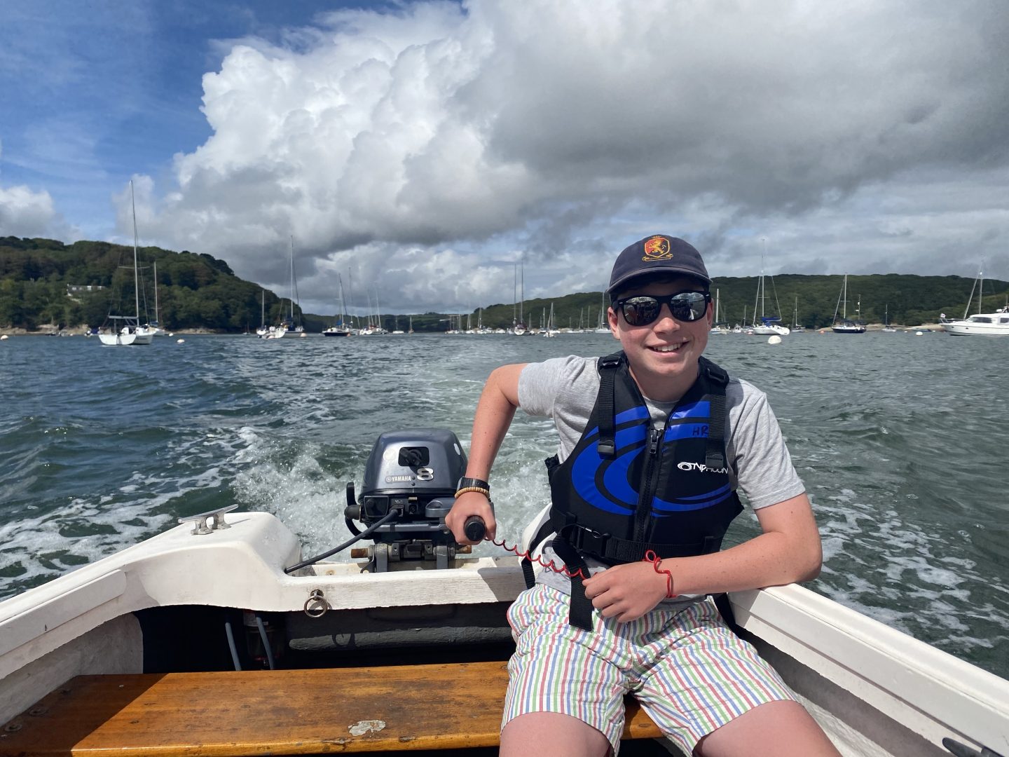 A boy driving a boat