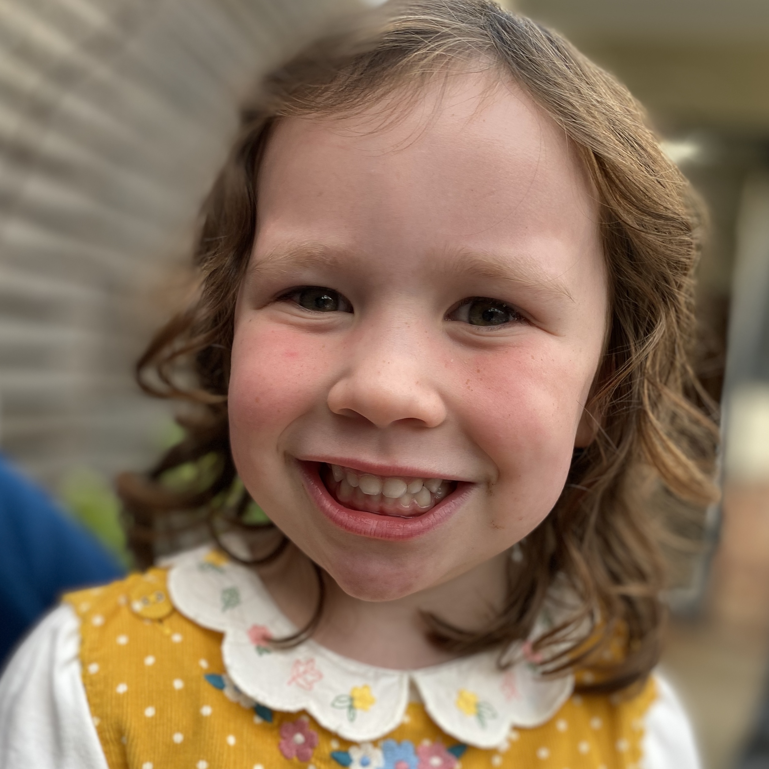 a child smiling into the camera