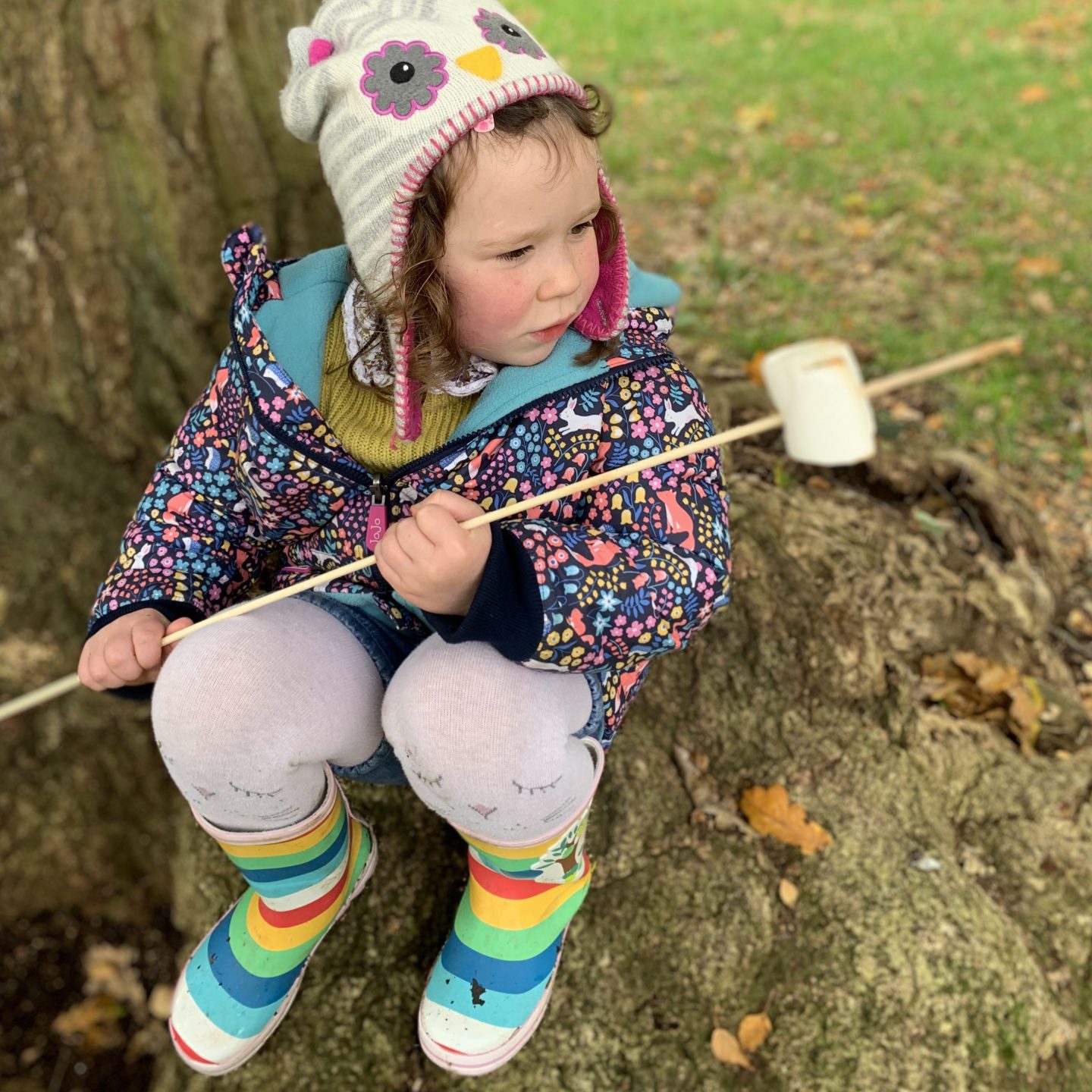 a girl roasting a marshmallow