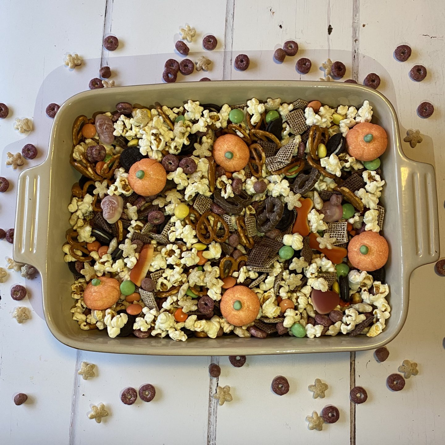 a serving dish filled with Halloween sweets and popcorn 