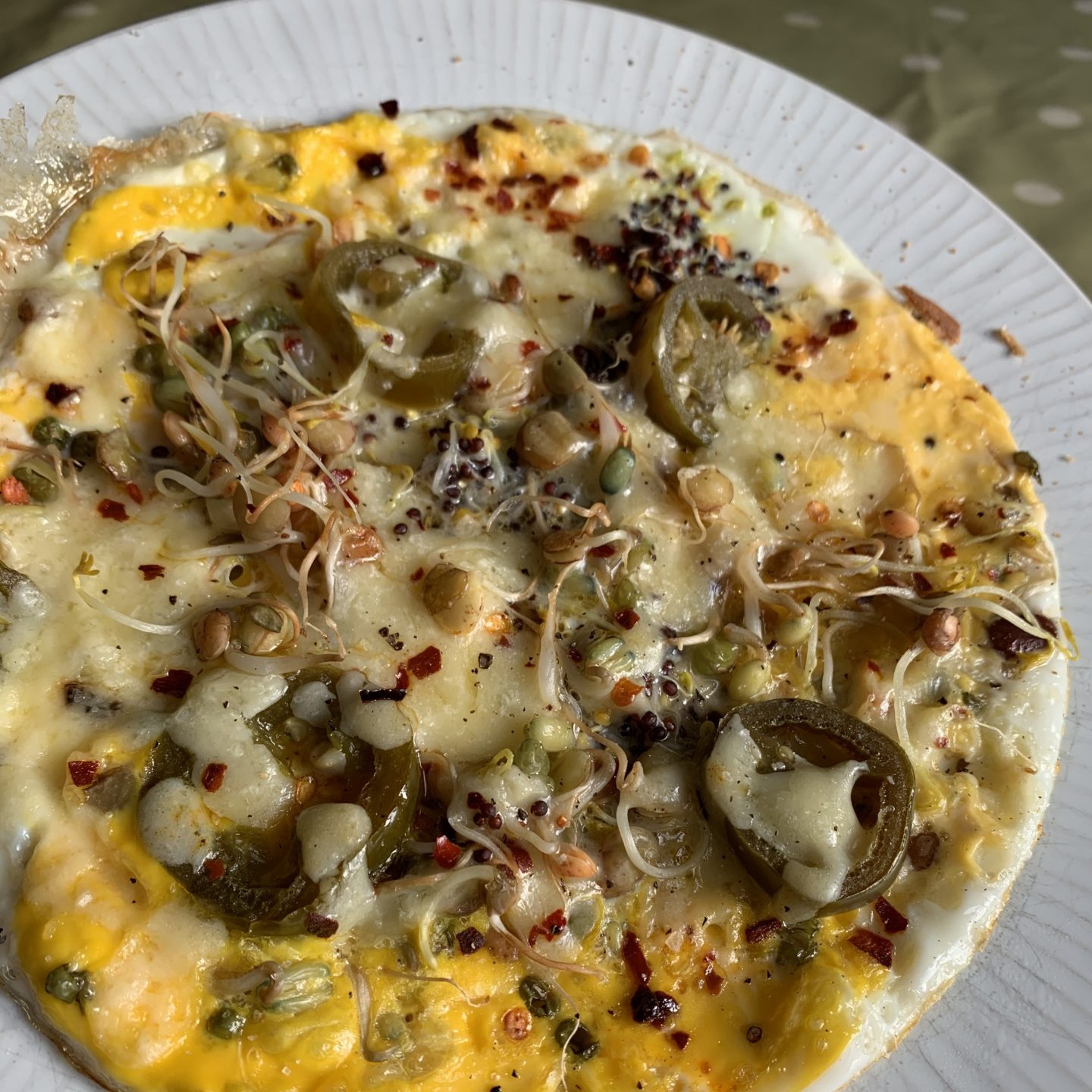 an omelette with sprouts on top
