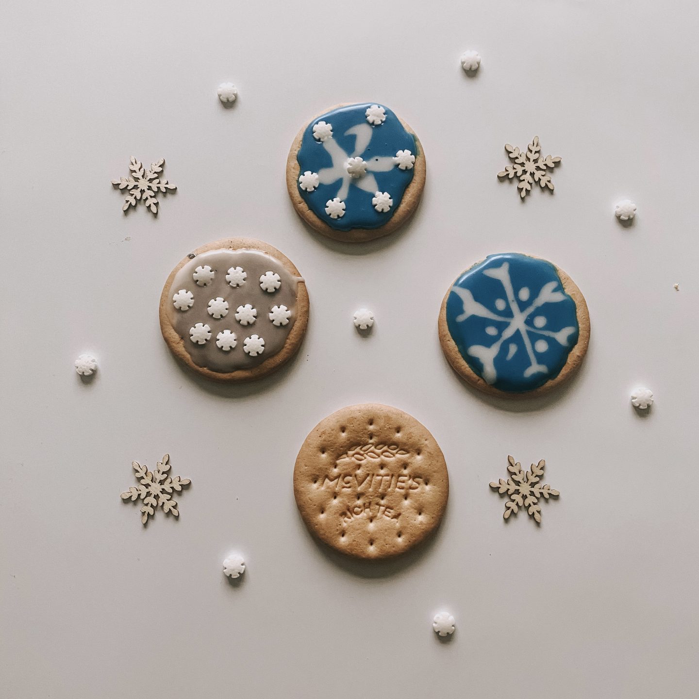 iced biscuits with blue icing and snowflake sprinkles