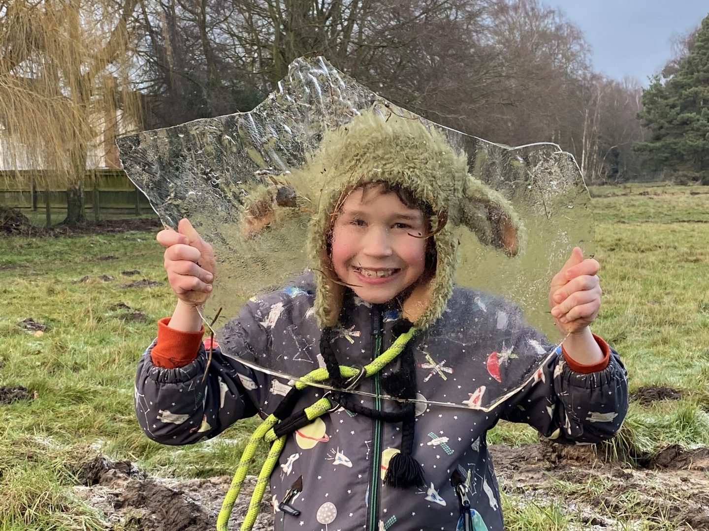 a young boy holding up ice and smiling