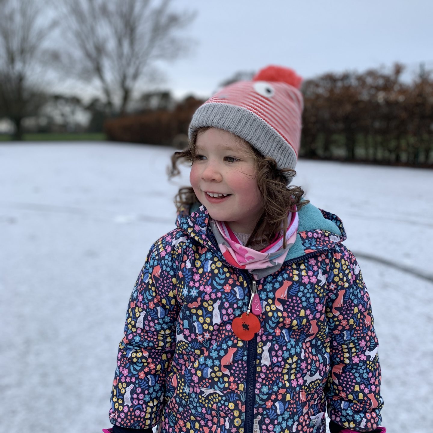 a young girl smiling in the snow