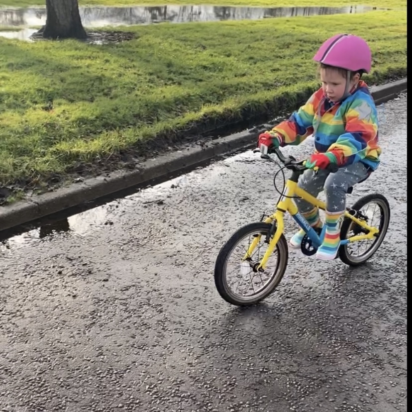 a small child cycling on a bike