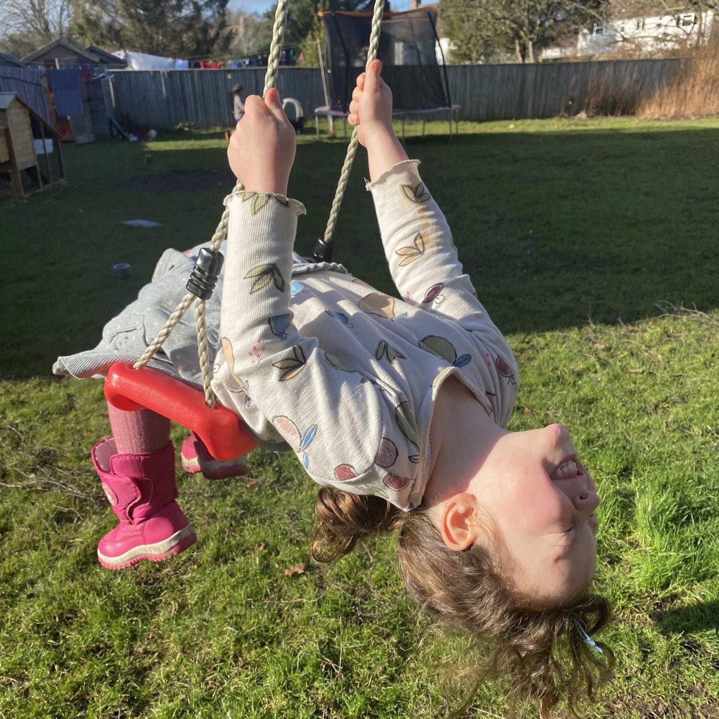 Springtime is coming witn a young girl on a swing