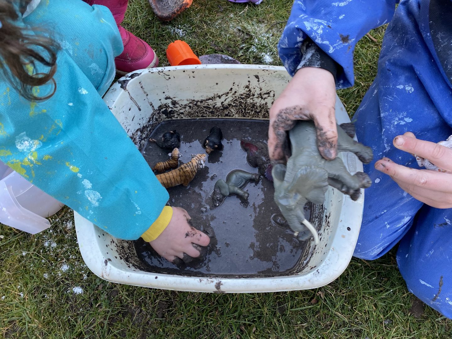 mud and cornflour in a bowl with Schleich animals around it