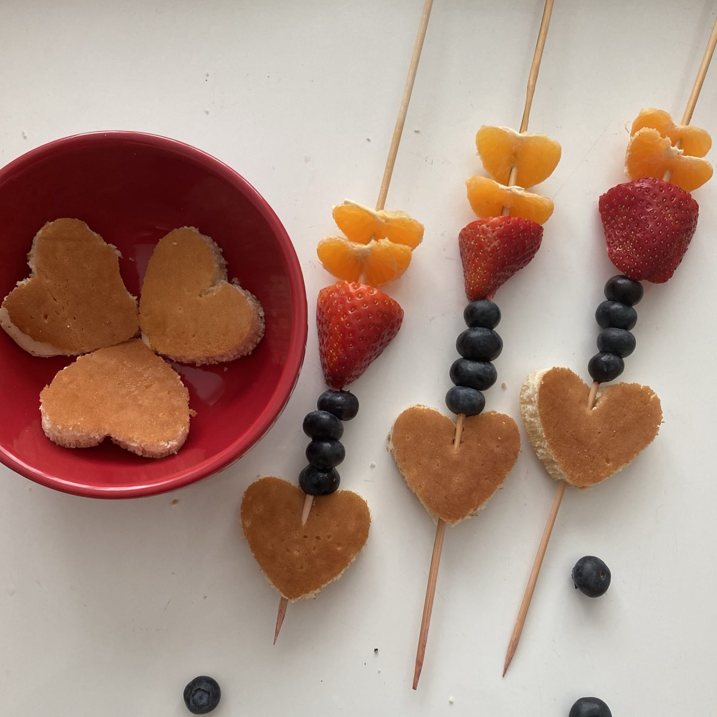 heart shaped pancakes on a kebab with fruit 