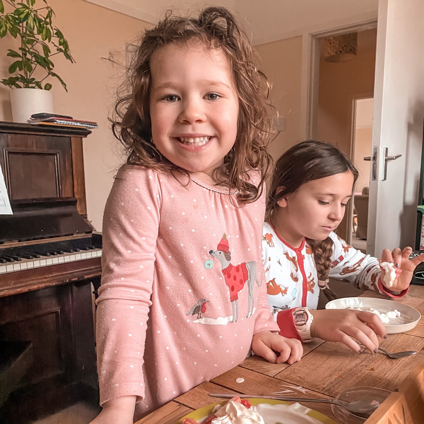 Valentine's baking with two girls eating valentines day waffles .
