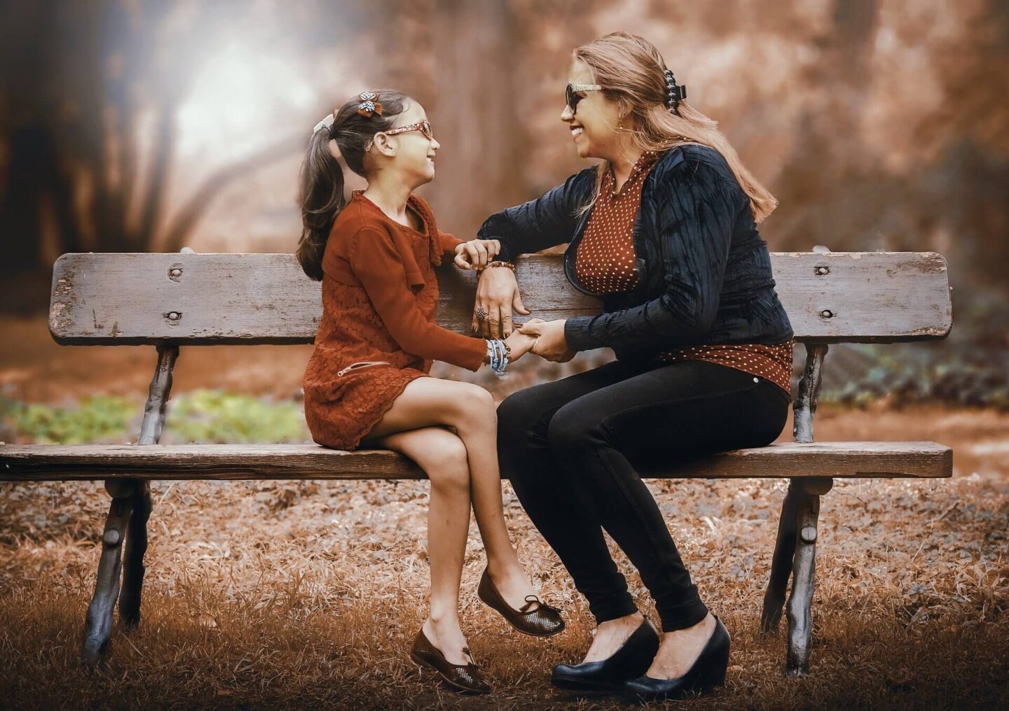 Exploring moral values with your child with a mum and daughter chatting on a bench together