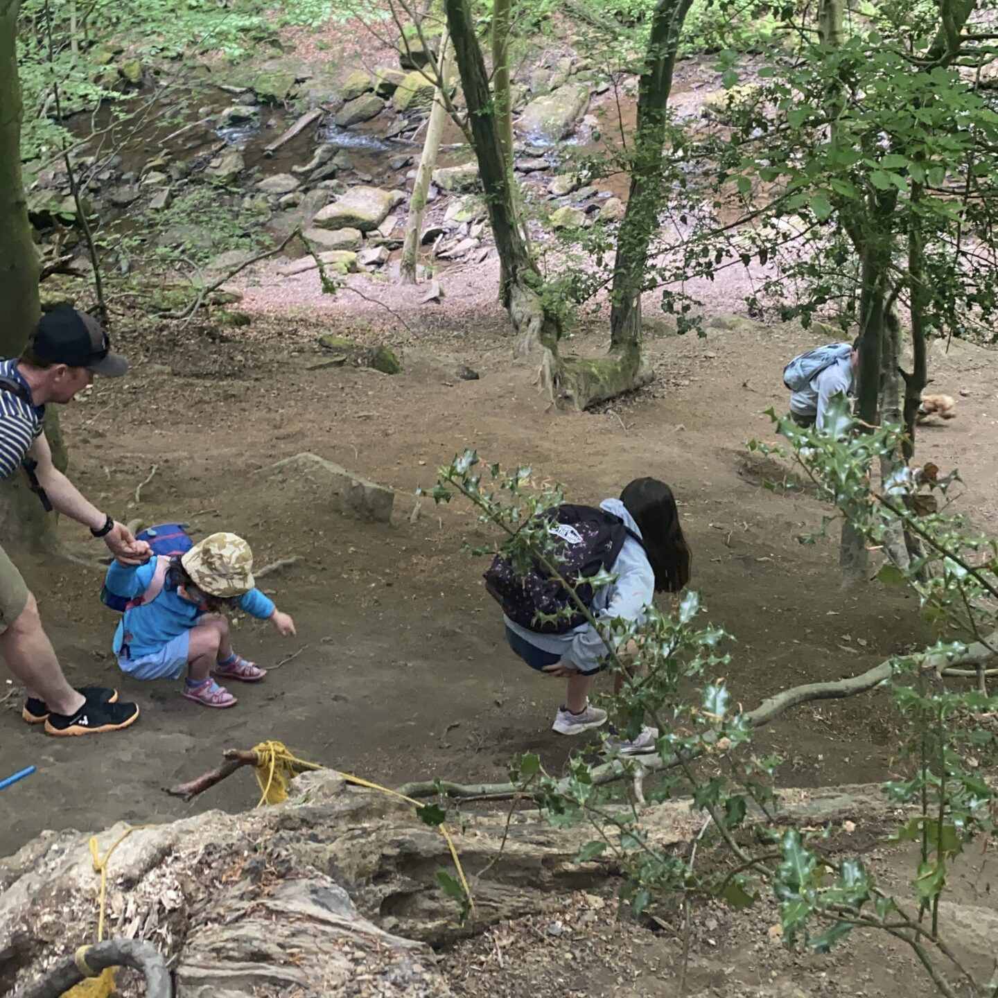 4 kids scrambling down to the river 