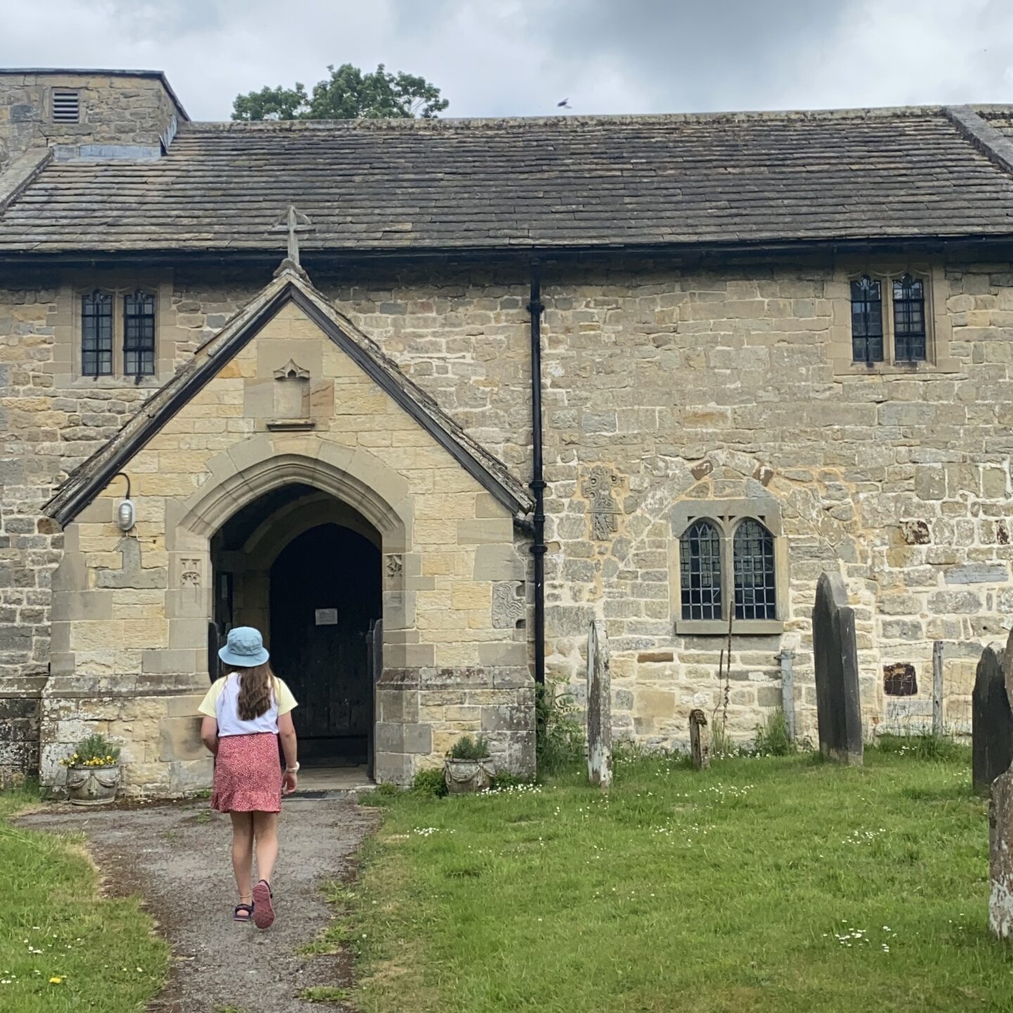 A young girl going towards a 12th century church in Ellerburn