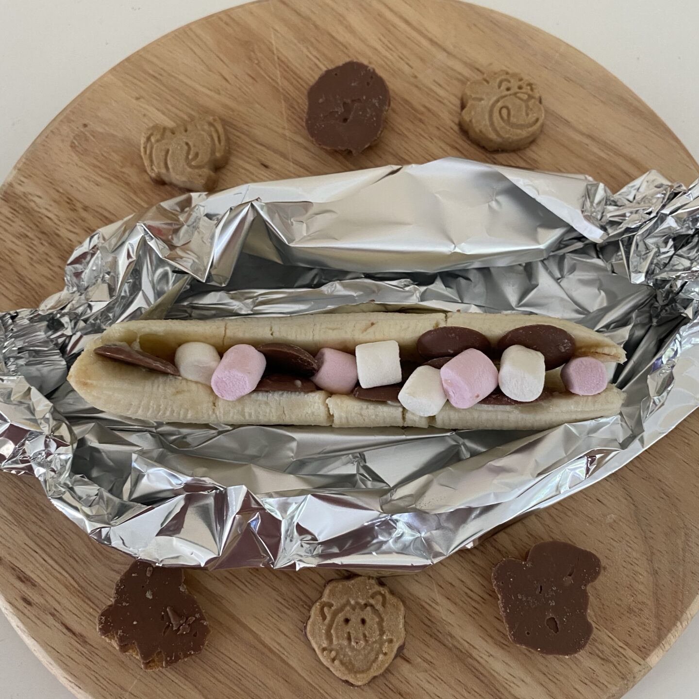 July activities for kids with a Banana with marshmallows, chocolate buttons and biscuits in it