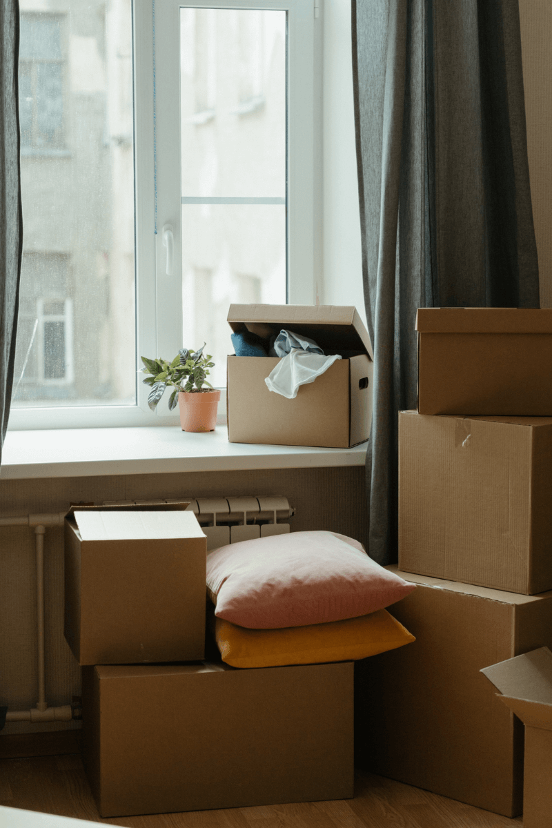 moving your family to a whole new location with a picture of boxes in a room by a window