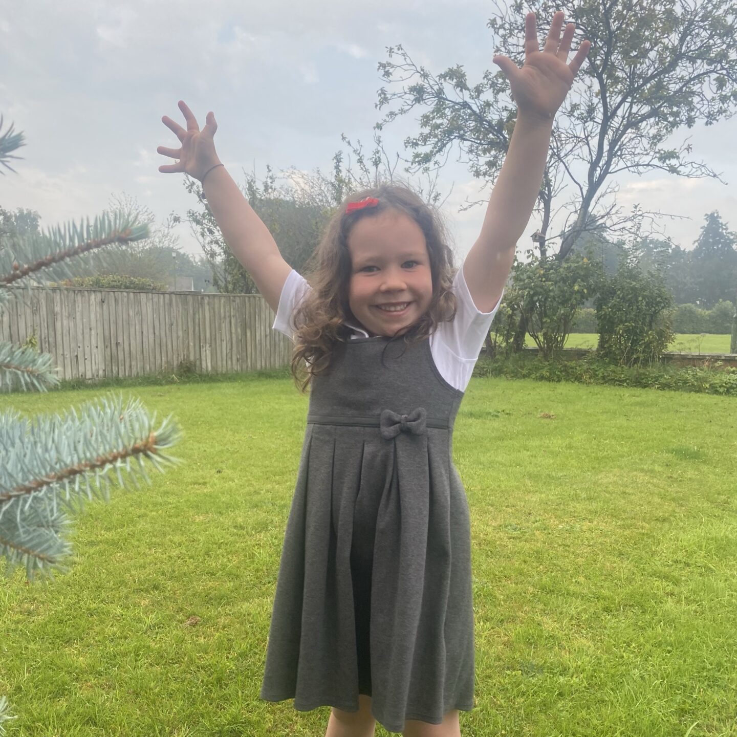 a girl in school uniform cheering