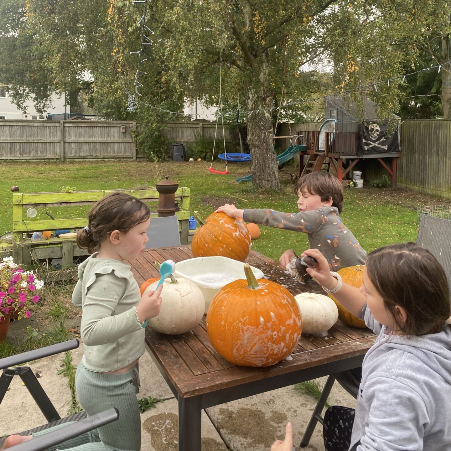 autumn activities with 3 kids washing their pumpkins
