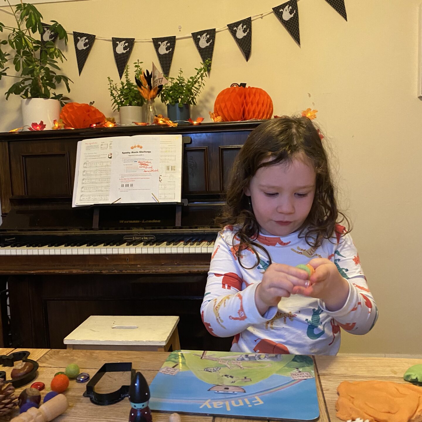 end of October activities with a girl playing with pumpkin play dough