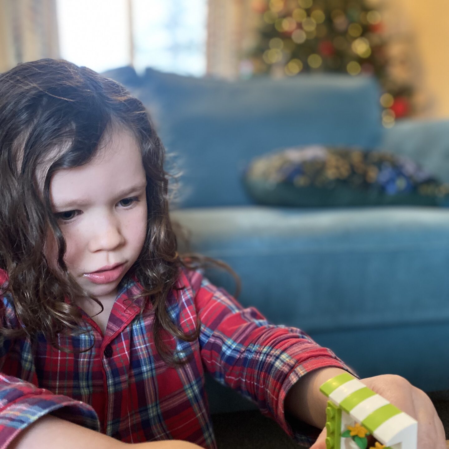 a girl building lego by the sofa on a chilled Christmassy weekend 