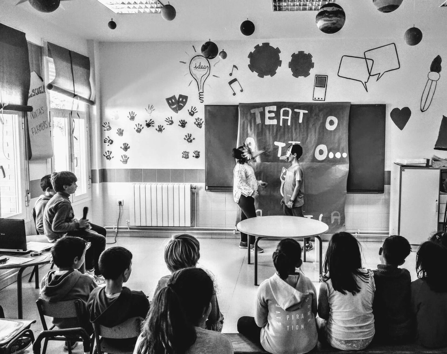 Benefits of Theatre School - a classroom of children watching two kids acting out a scene