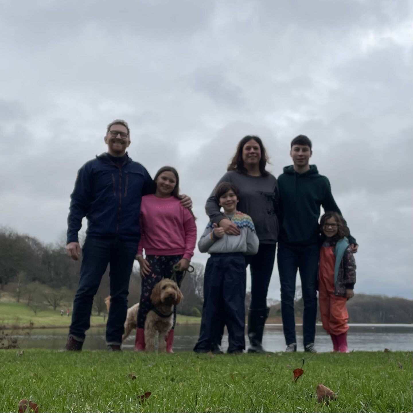 New Year family photo - a family of 6 smiling on a walk outdoors