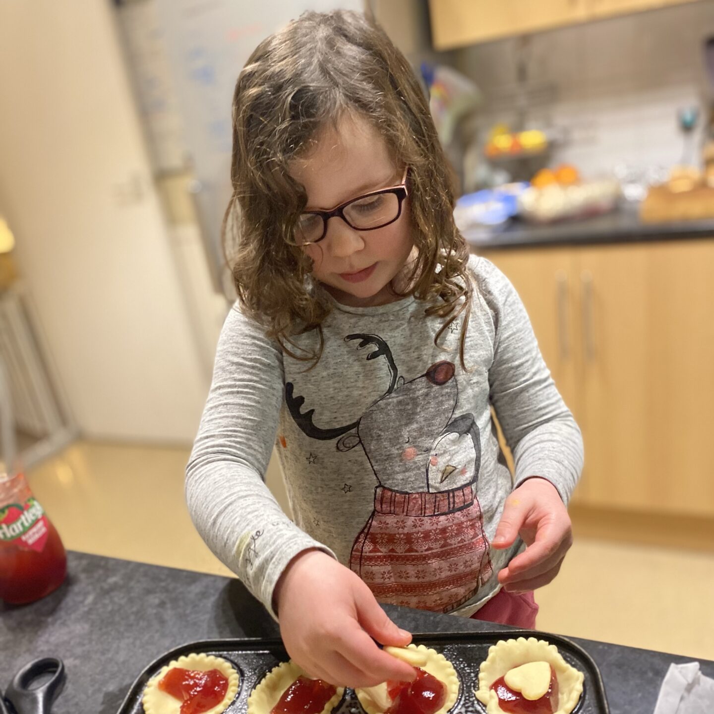a long week with living arrows - a young girl making jam tarts in the kitchen.