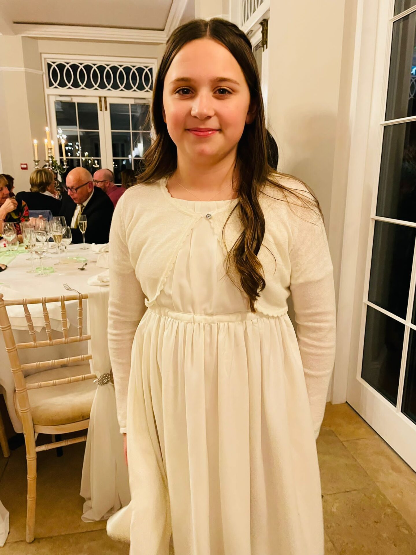 a young girl dressed as bridesmaid