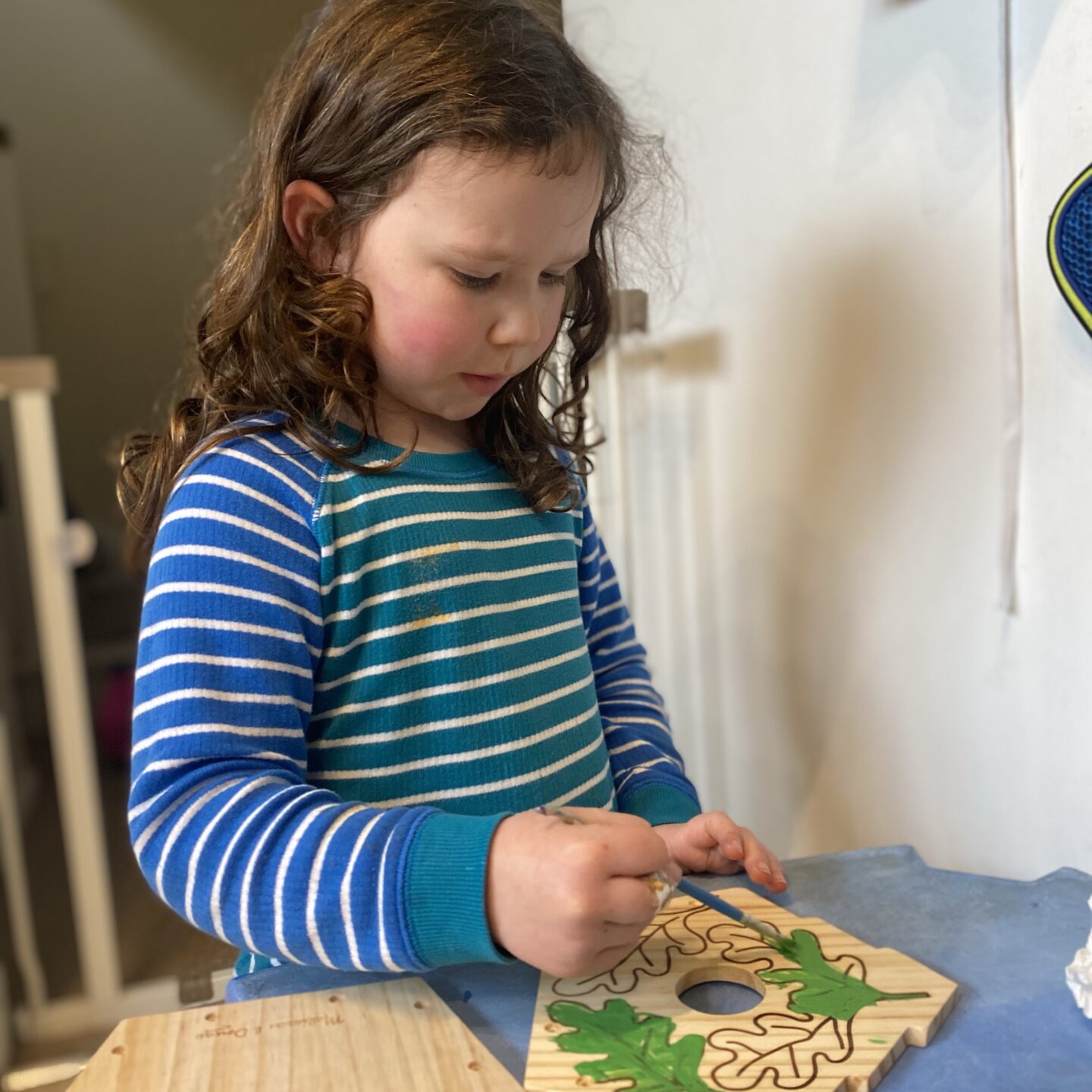 Stormy week with a girl painting a wooden craft