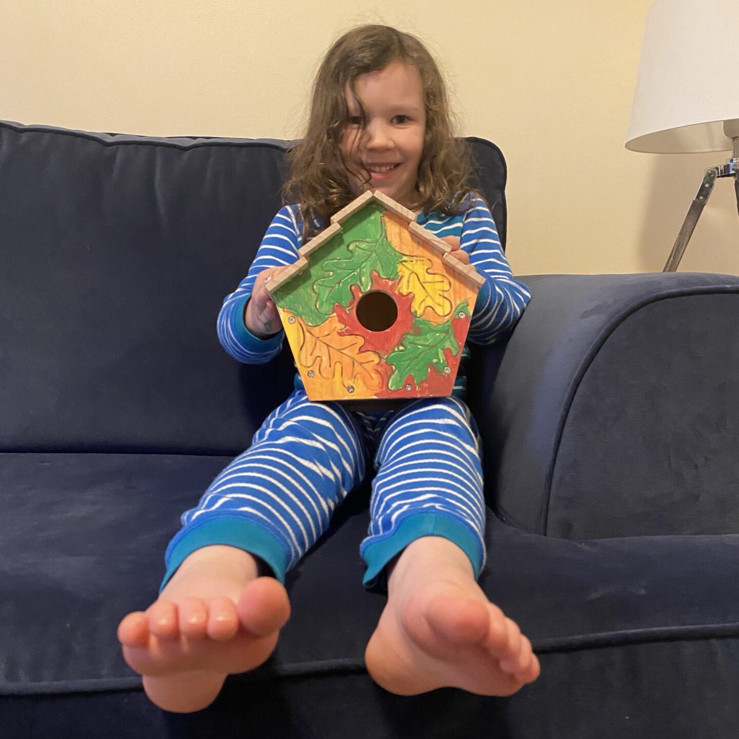 a girl holding a nesting bird box