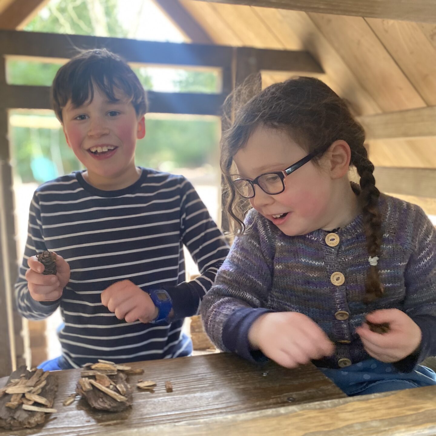 2 children laughing in a play house