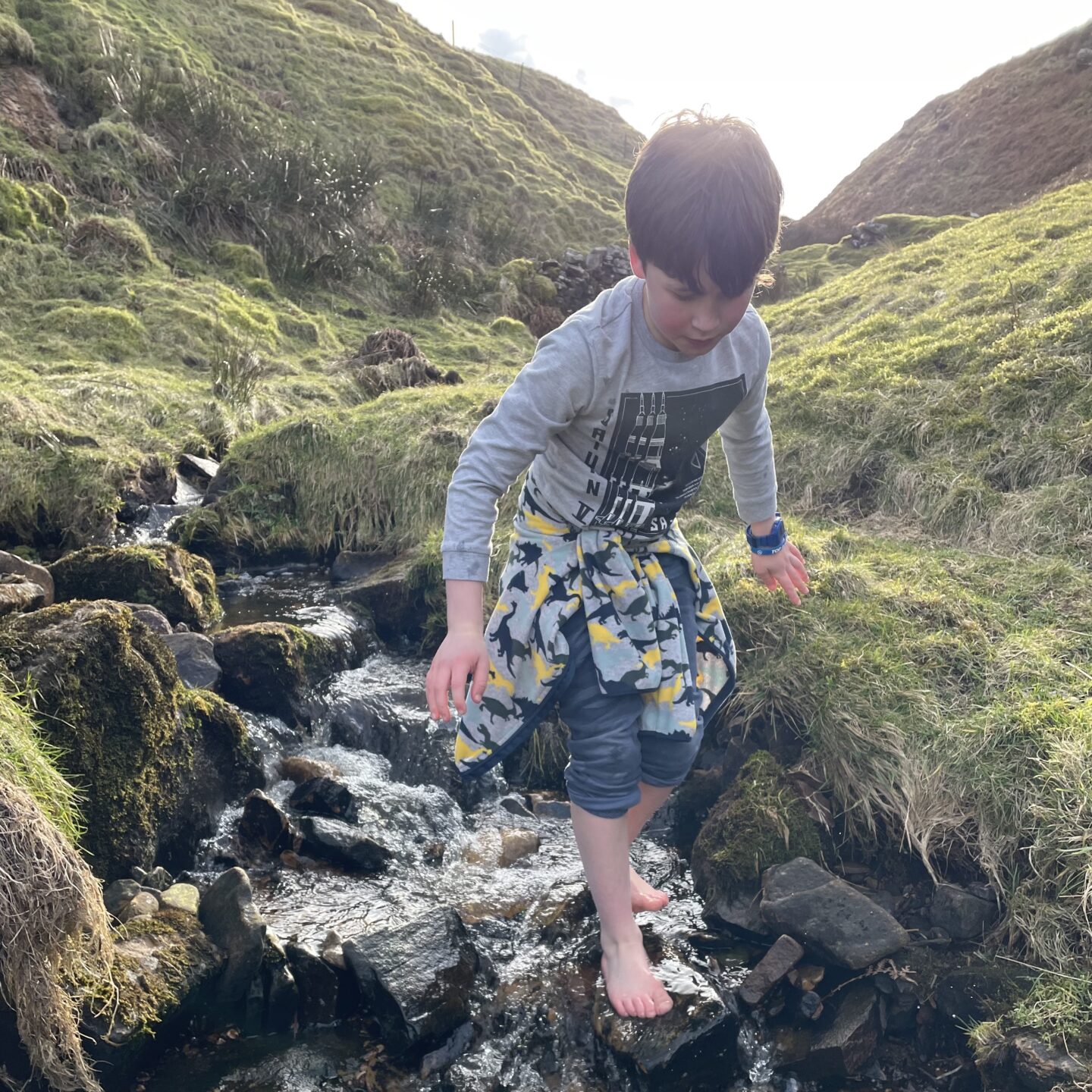 a boy on a Yorkshire dales hike- playing in a stream